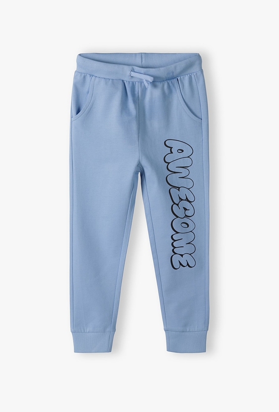 Dresowe spodnie slim dla chłopca - niebieskie z napisem Awesome