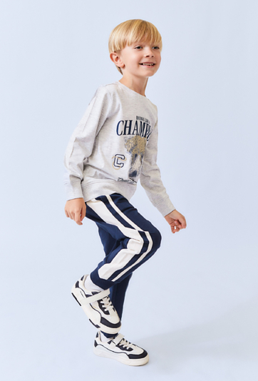 Granatowe spodnie dresowe dla chłopca z białymi lampasami