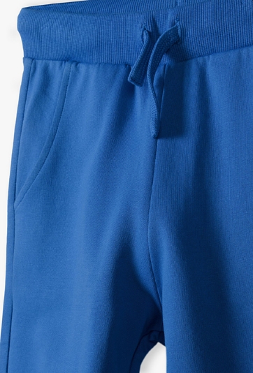 Niebieskie spodnie dresowe dla chłopca - New Generation