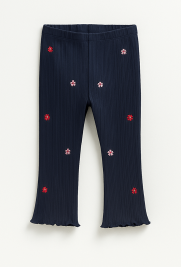 Granatowe legginsy dziewczęce z kwiatowymi naszywkami.