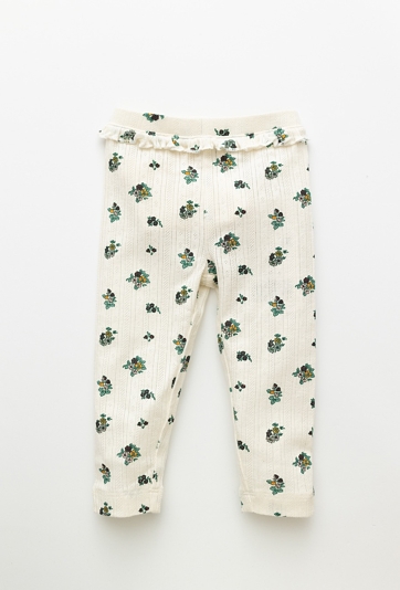 Białe legginsy niemowlęce w kwiatuszki z materiału pointelle