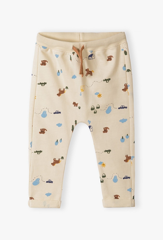 Beżowe bawełniane spodnie dresowe niemowlęce z nadrukiem