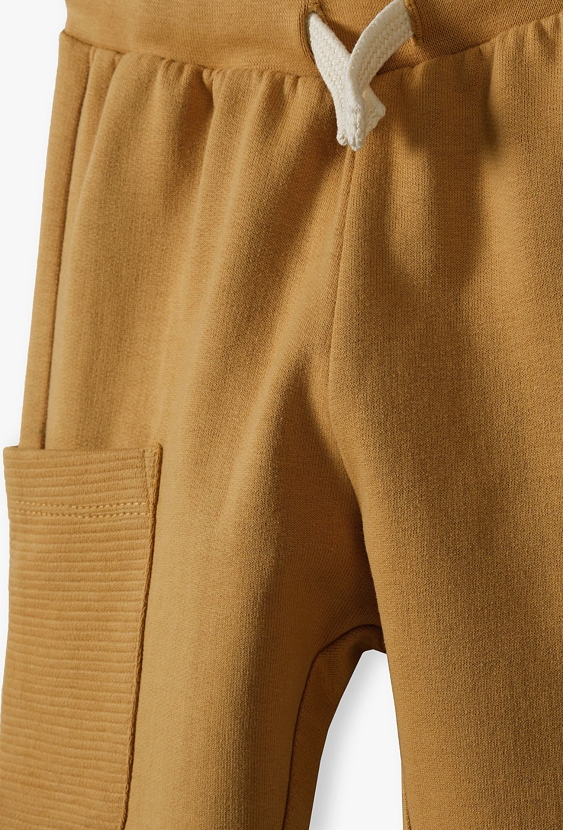 Bawełniane spodnie dresowe niemowlęce z kieszeniami