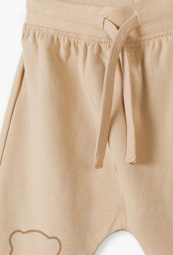 Beżowe bawełniane spodnie dresowe niemowlęce