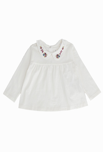 Biała bluzka dziewczęca z haftowanym kołnierzykiem.