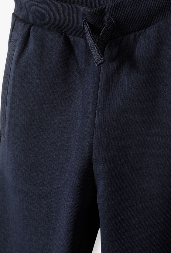 Spodnie dresowe dla chłopca - granatowe -slim